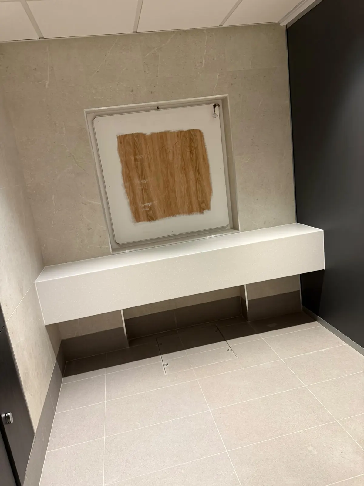 Vanity shelf and mirror recess set into a Unika Light 600 × 600 tiled wall