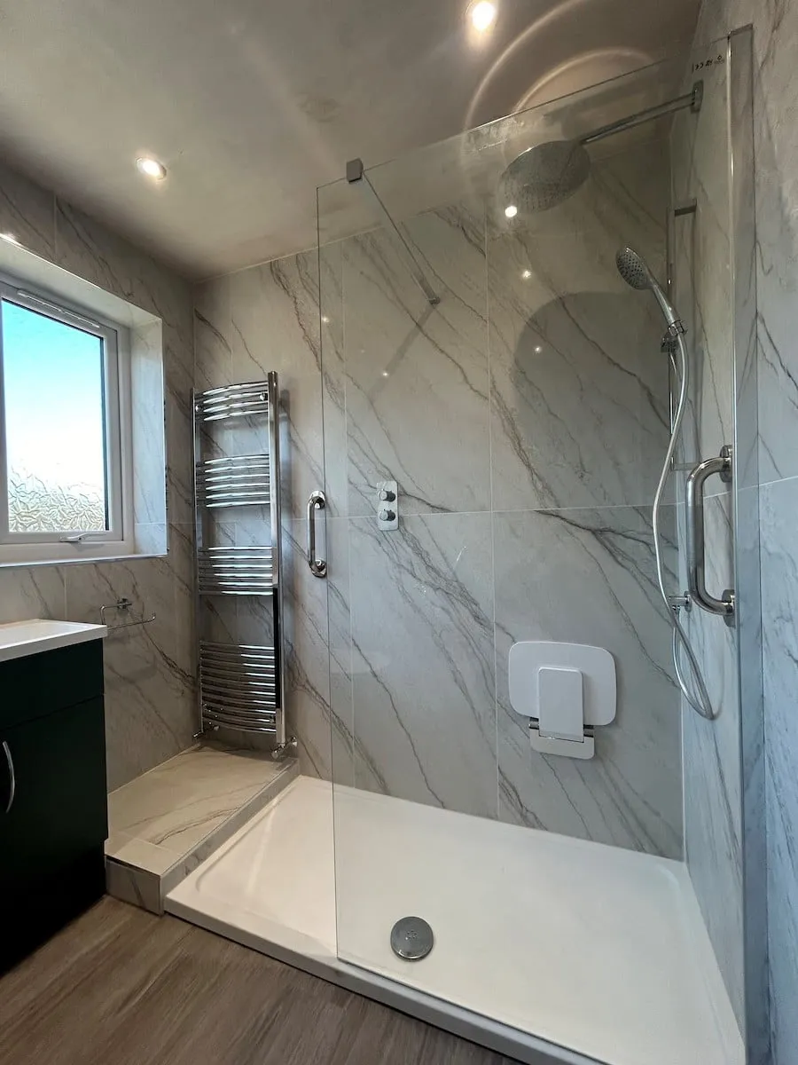 Walk-in shower in white marble-effect porcelain with grab rails and a fold-down seat, Walton-le-Dale