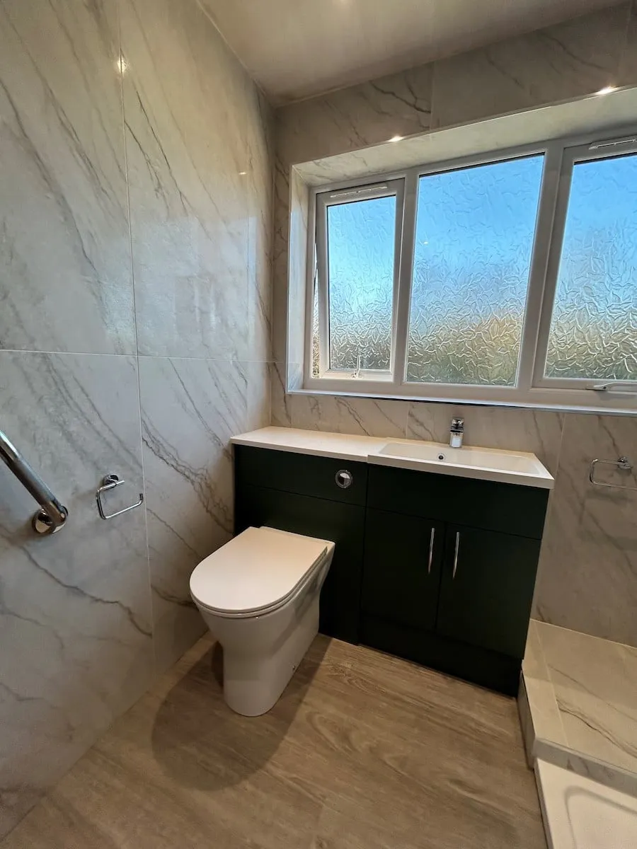 Chrome trim finishing the tiled window reveal above the vanity
