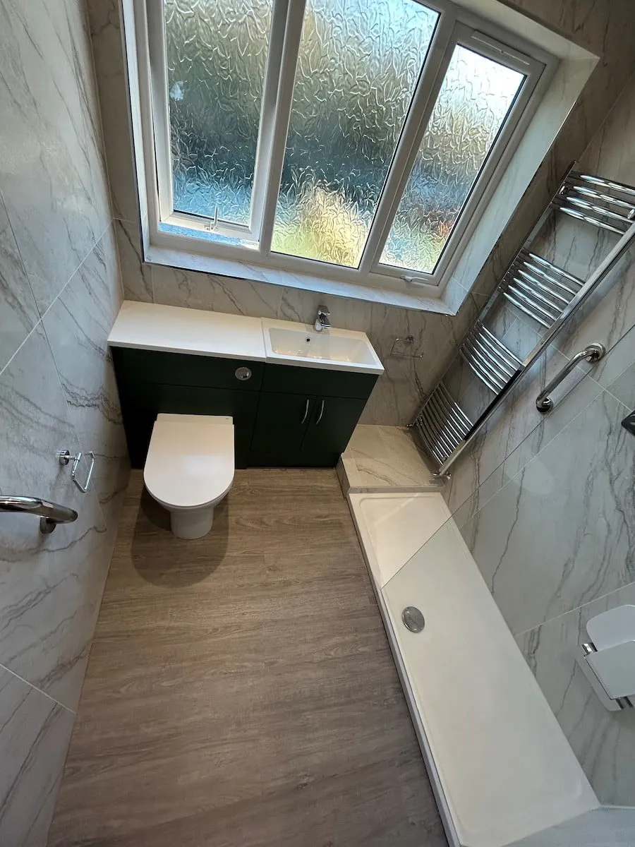 Walk-in shower tray, towel rail and grab rails along the wall