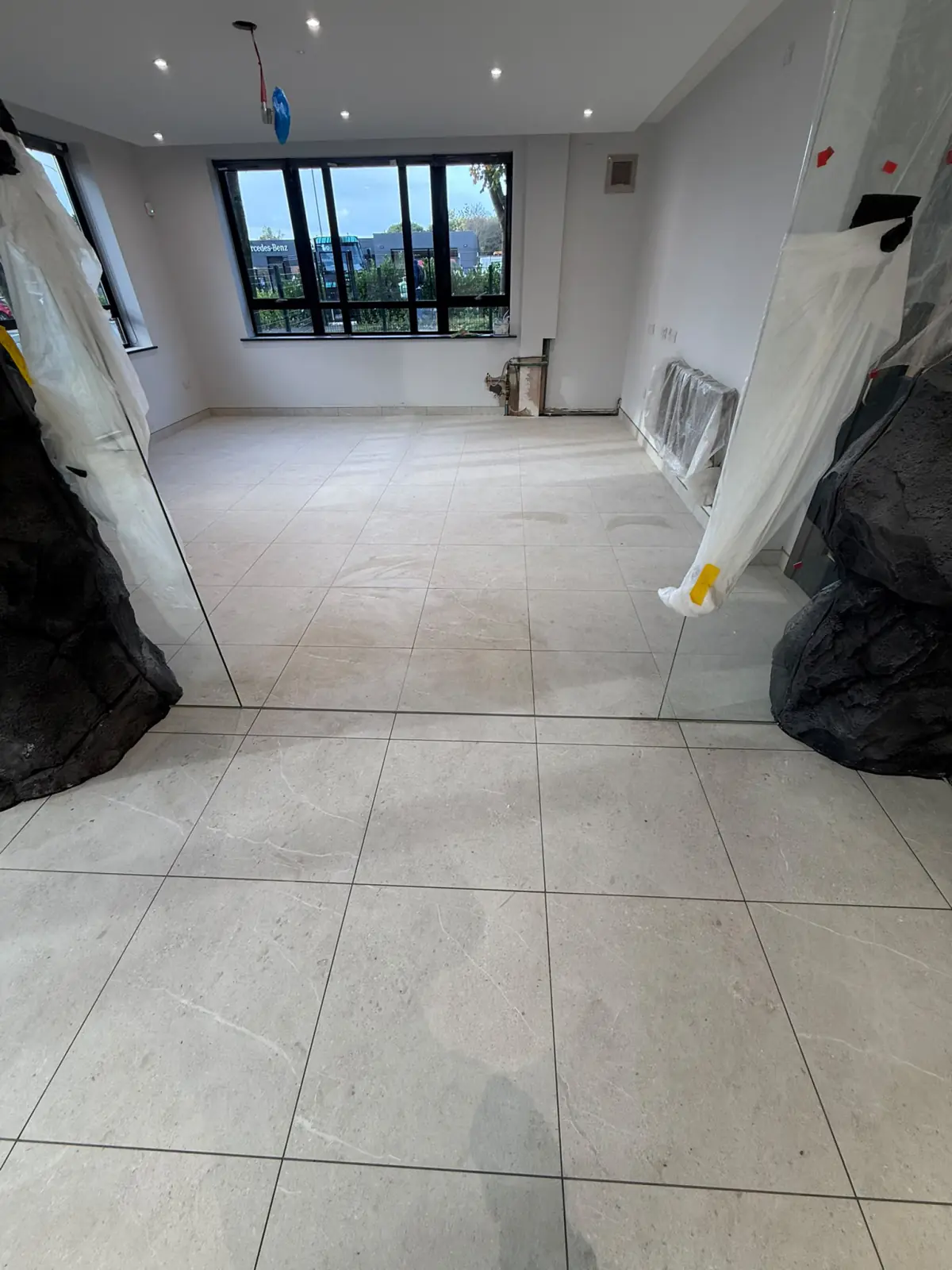 Unika Light 600 × 600 floor tiles across the open-plan office at Multevo’s head office in Darwen, with rock cladding and glazed walls