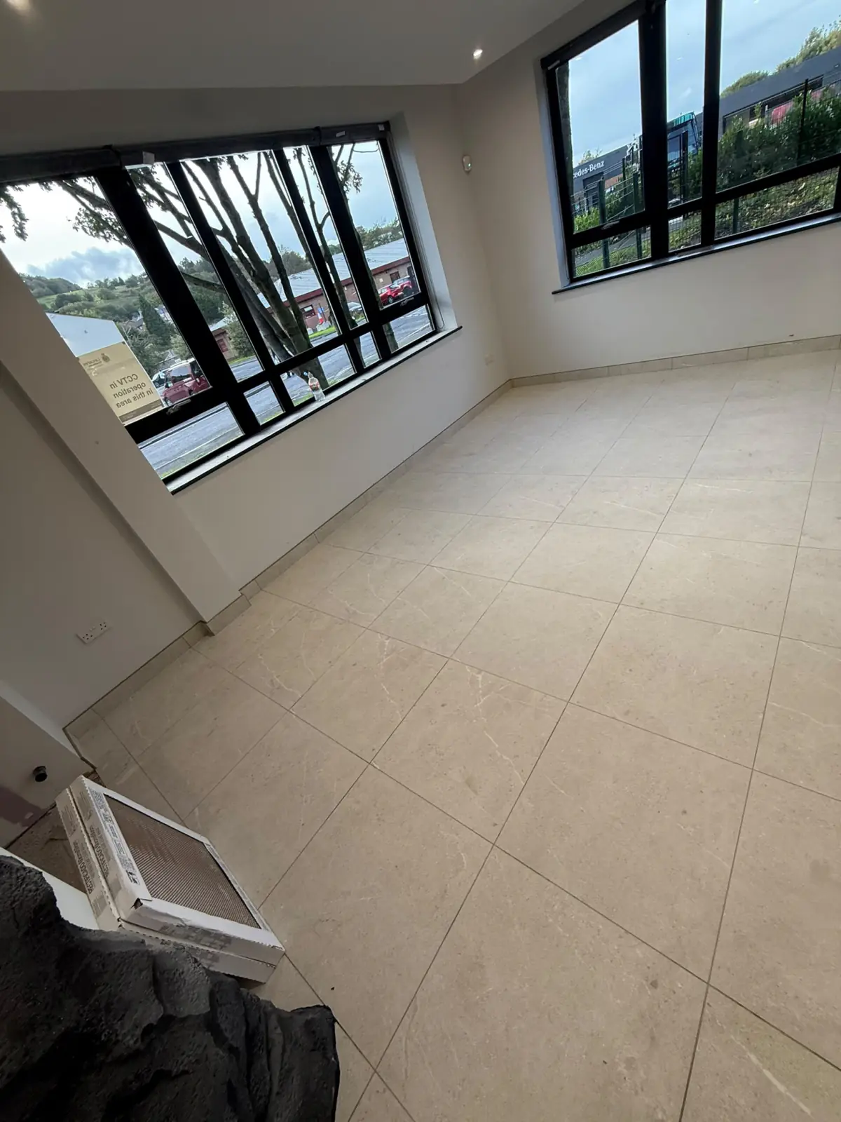 Tiles laid square to the window wall in a corner office
