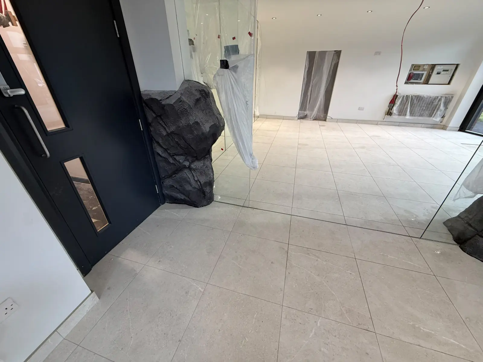 Reception floor at the entrance door, beside the rock cladding