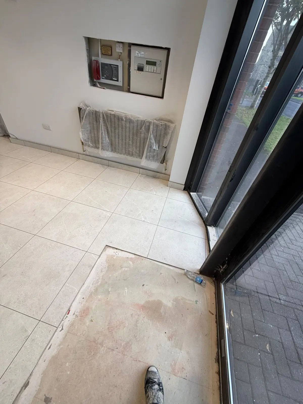 Clean tile edge at the entrance matwell, ready for matting