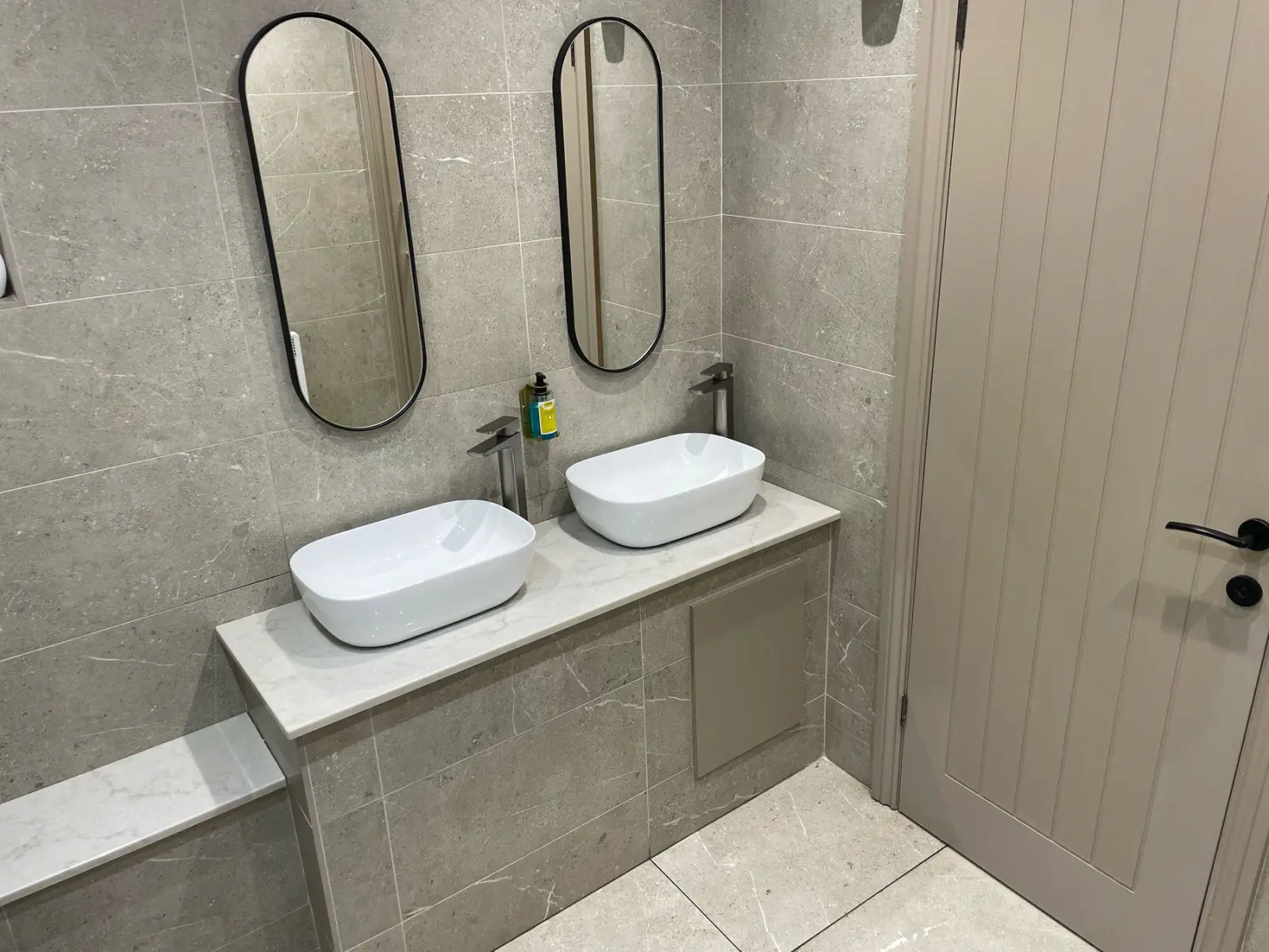 Gents vanity with twin basins on a tiled plinth, walls and floor in Unika Bone porcelain, Swan & Royal, Clitheroe