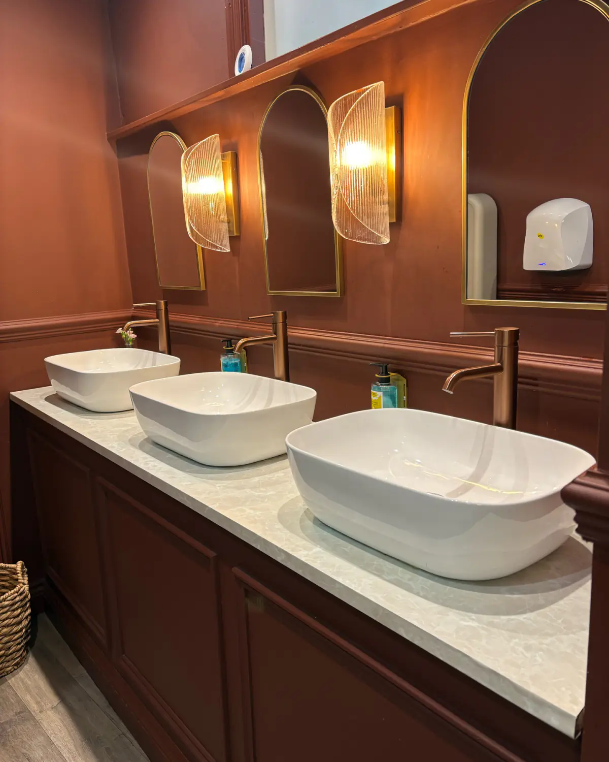 Ladies vanity with copper taps and arched mirrors