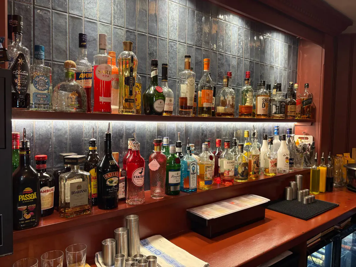Back bar wall in Nexti Ocean 30 × 60 gloss tiles behind lit spirit shelves, Swan & Royal, Clitheroe