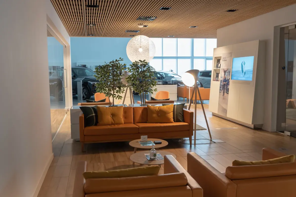 Car dealership customer lounge with a wood-effect porcelain plank floor