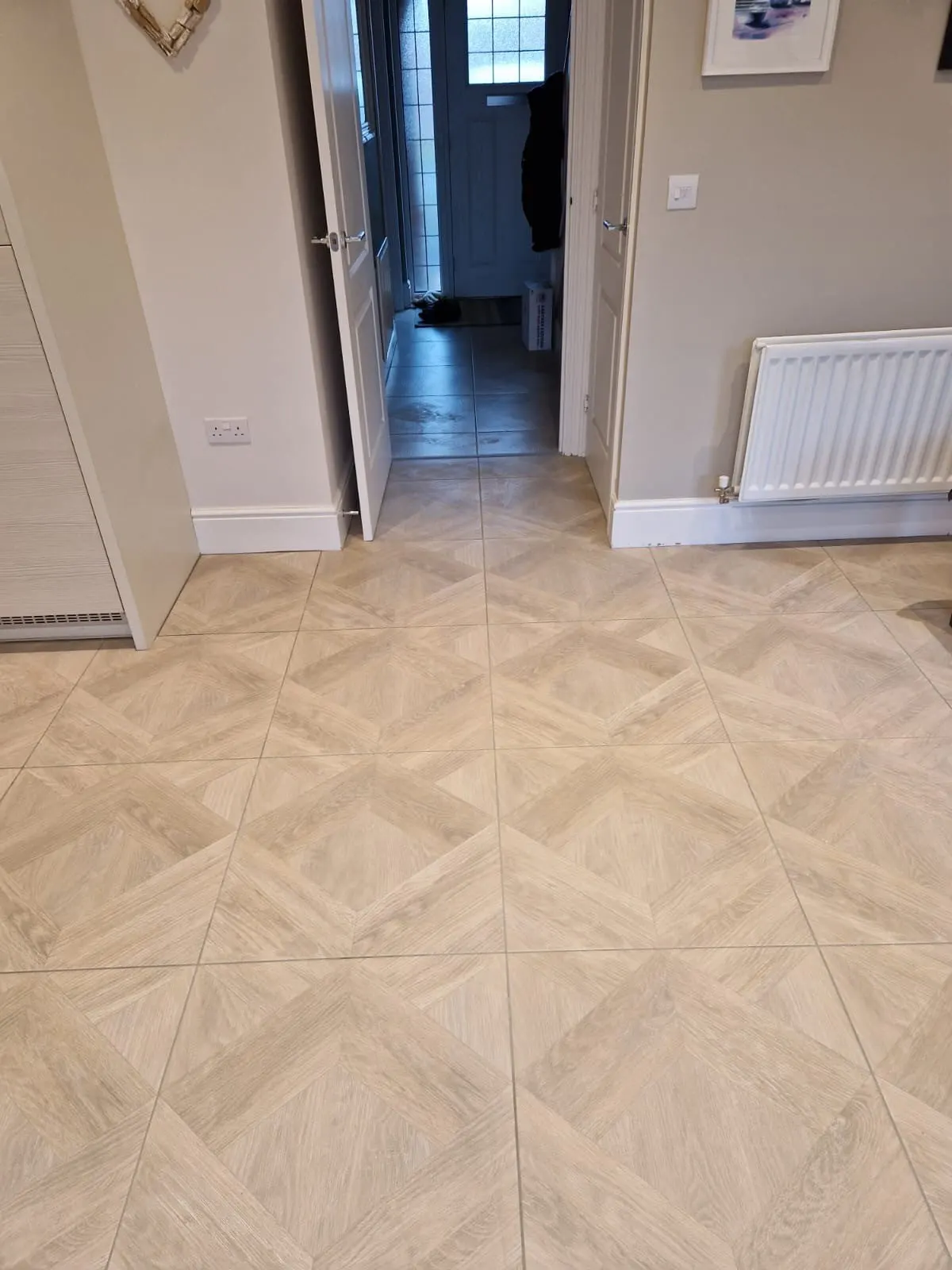 Cream diamond-pattern floor tiles running through a hallway