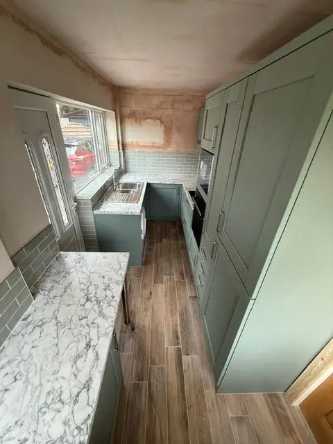 Plank floor laid down the length of a galley kitchen
