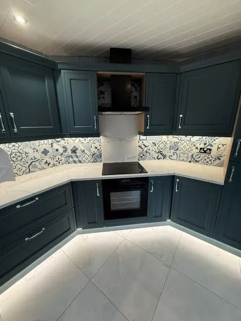 Viridian kitchen with patterned tiles, wall to ceiling