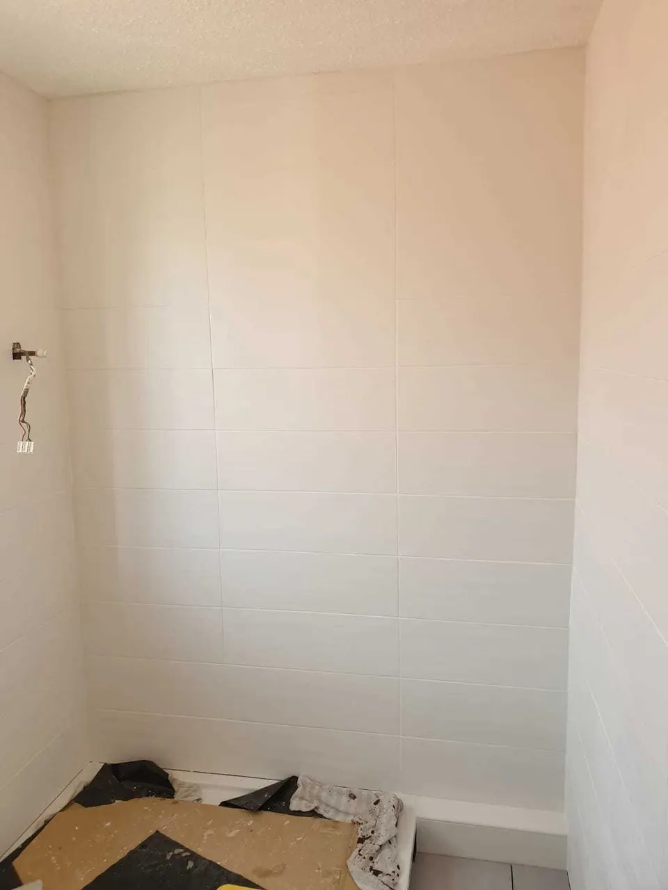 White ceramic tiling in a small bathroom