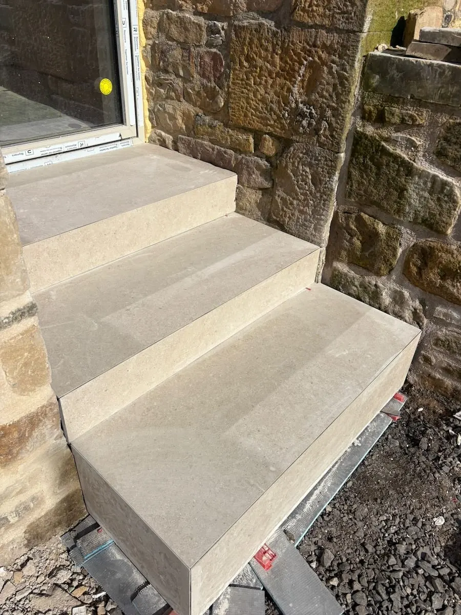 Light porcelain garden steps beside a sandstone wall, Springwood, Hurst Green