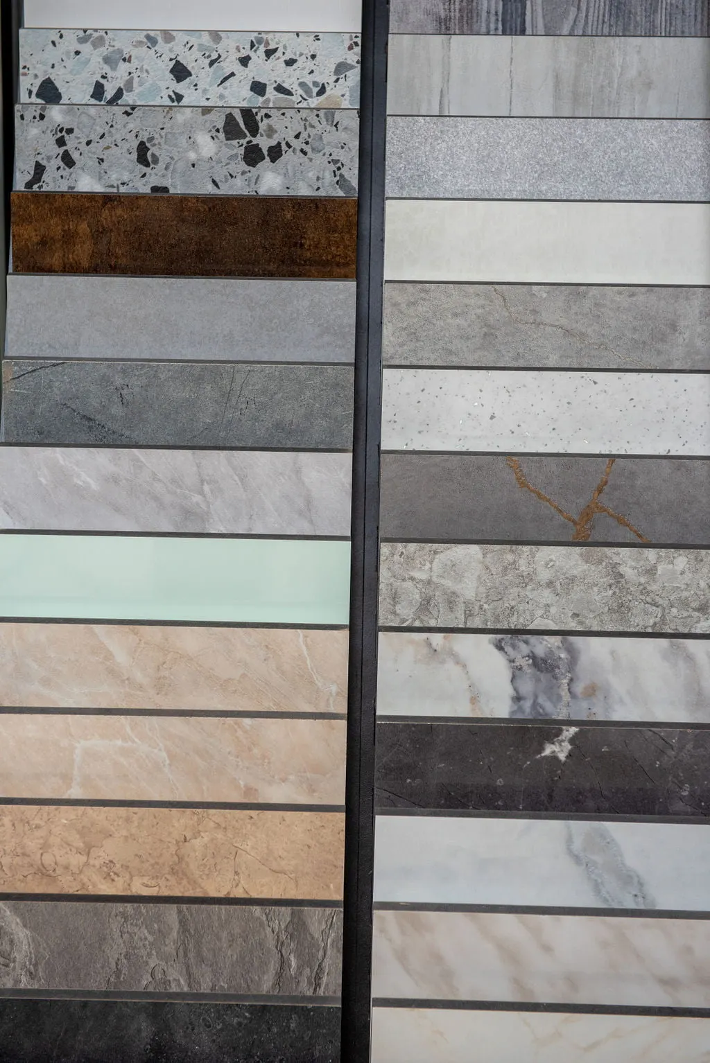 Wall of stone and marble tile samples in the Homematas showroom